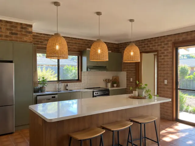 Three woven pendant lights over a kitchen island in a brick-walled home in Glendale